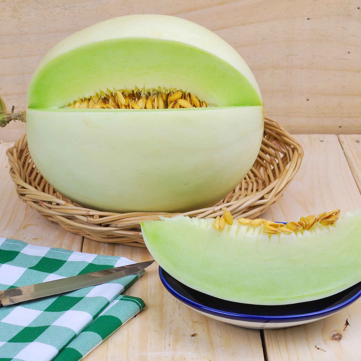 A vibrant green honeydew melon in a wicker basket with a slice cut out next to it showing green flesh and seeds.