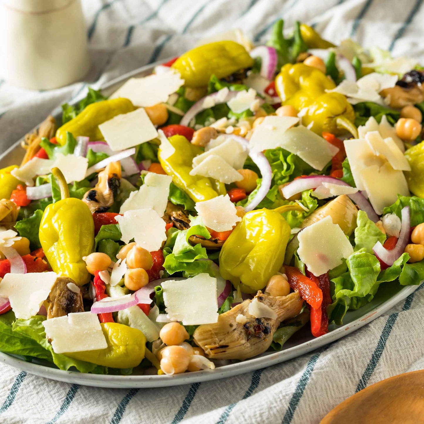 A coloful salad with Pepperoncini Italian peppers showcased.