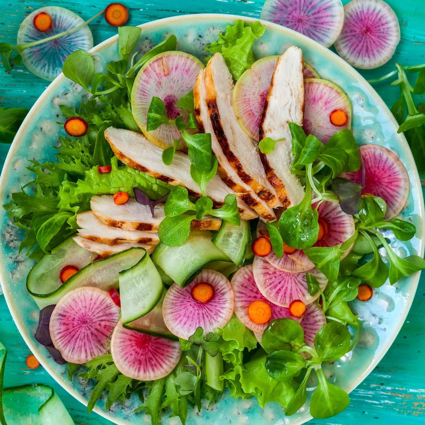 A salad made of greens and Watermelon Radish.
