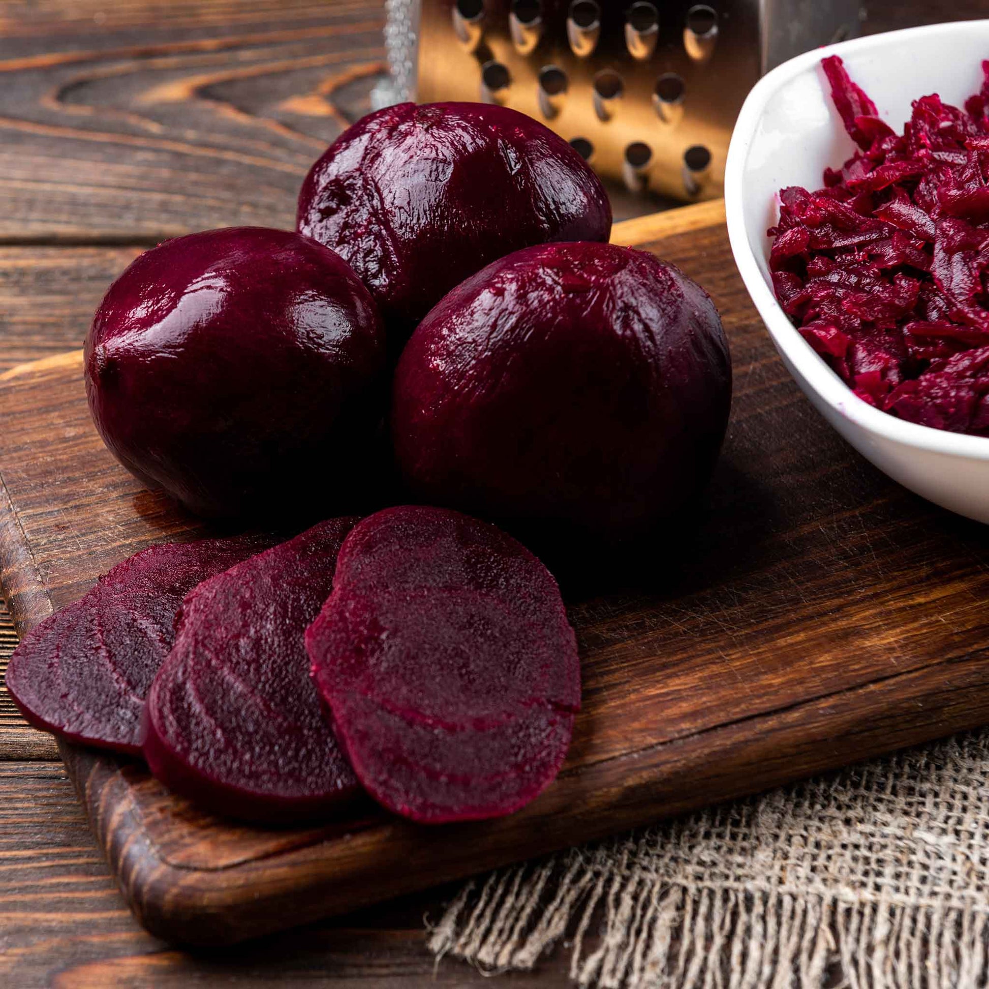 A close-up of harvested Detroit Dark Red beets, showcasing their deep red color and smooth skin.
