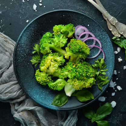 A plate of cooked calabrese broccoli florets ready to eat.