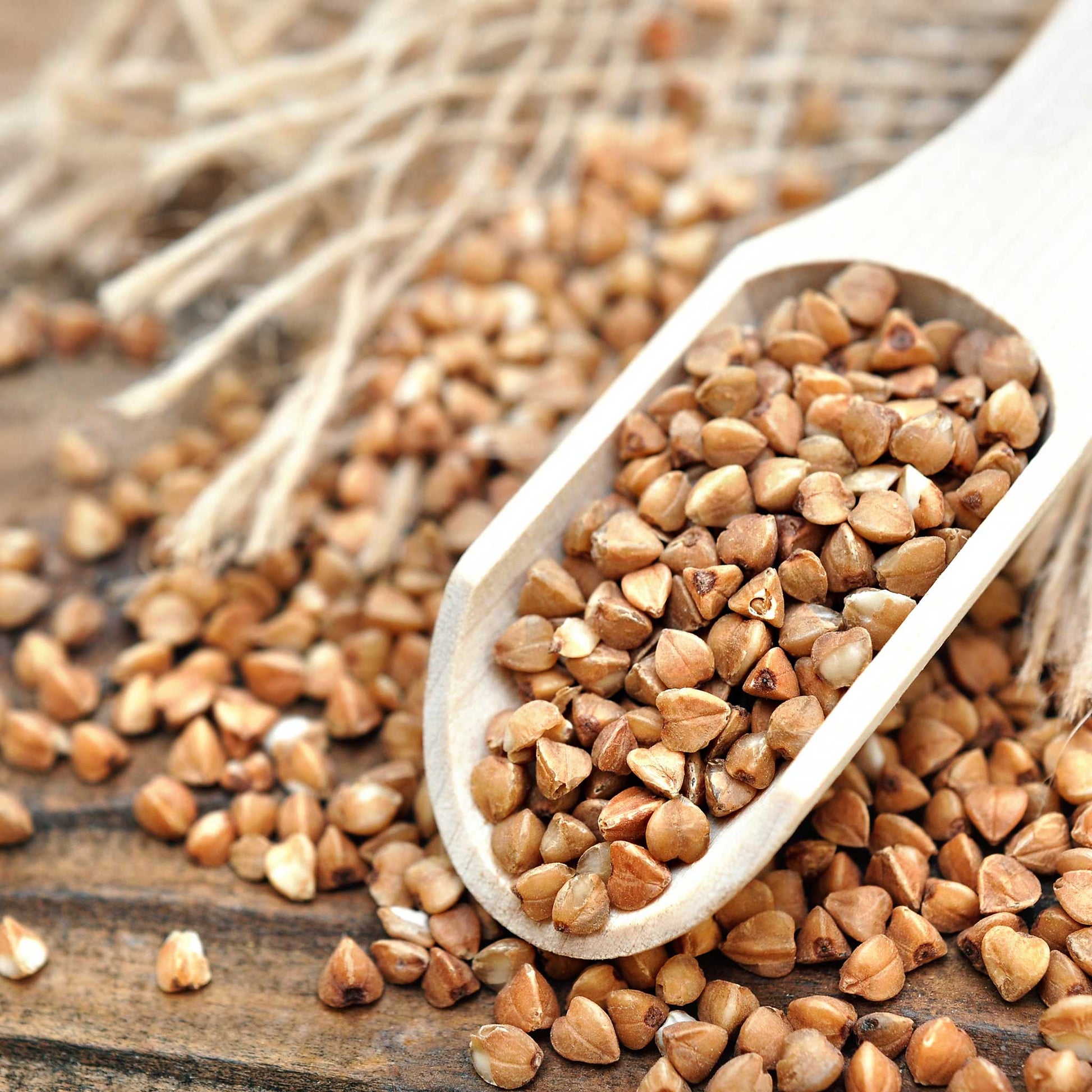 A close-up of light brown buckwheat seeds with a blurred background.