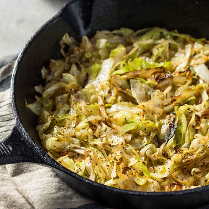 A skillet of food containing brunswick cabbage.