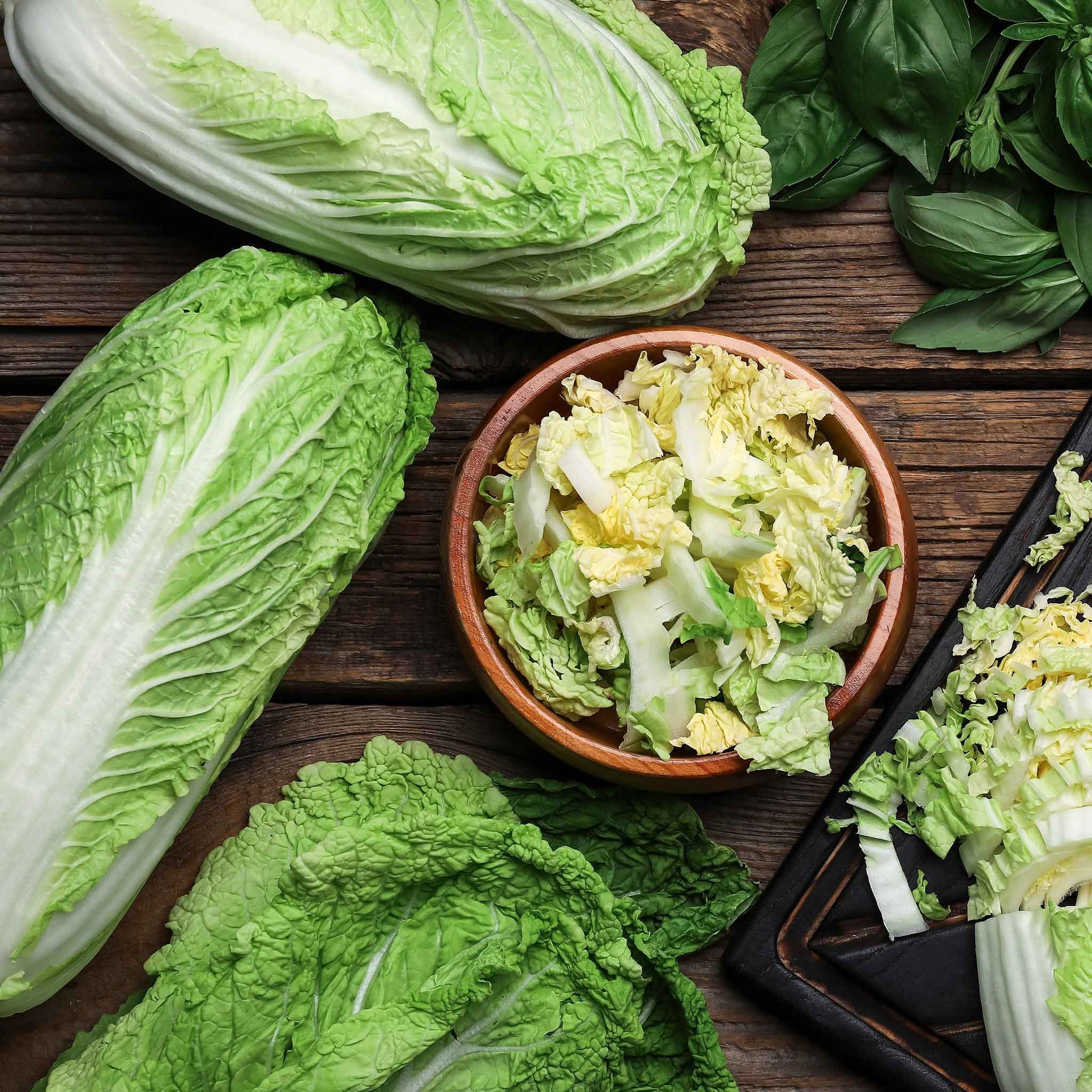 A vivid green, elongated head of Michihili Chinese cabbage against a blurred background.