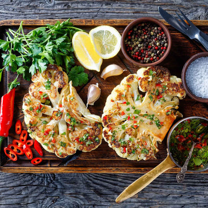 A plate of grilled Snowball Y Improved cauliflower with garnish and other vegetables.