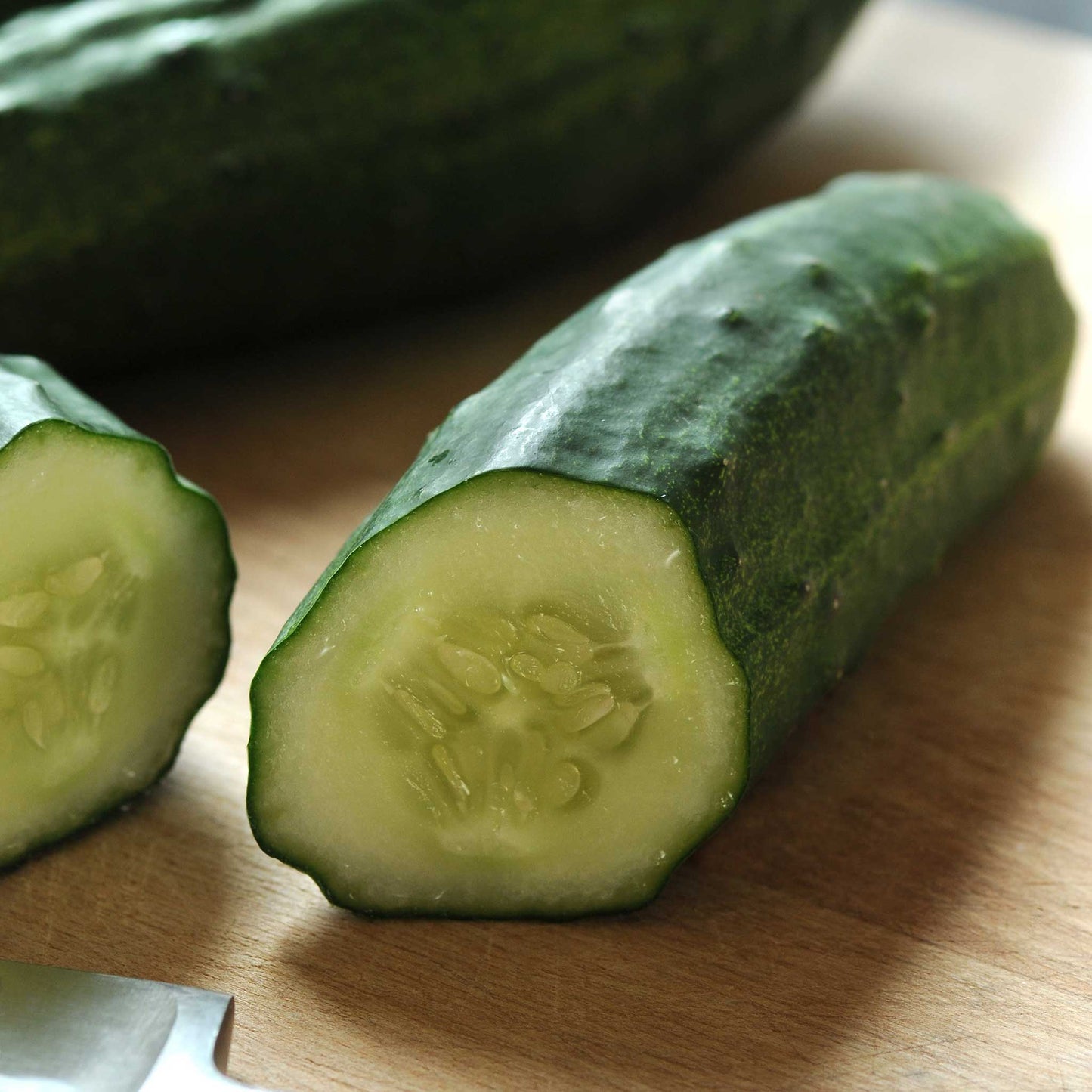 A patio snacker cucumber cut open showing pale flesh and seedy center.