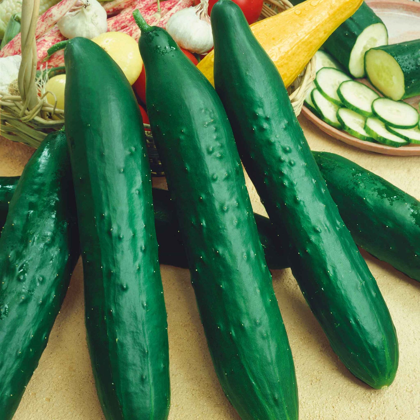 Long, dark green, and slightly bumpy Sweet Success cucumbers on a table.
