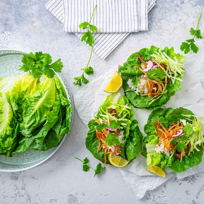 A plate of little gem lettuce next to salads made using little gem lettuce.