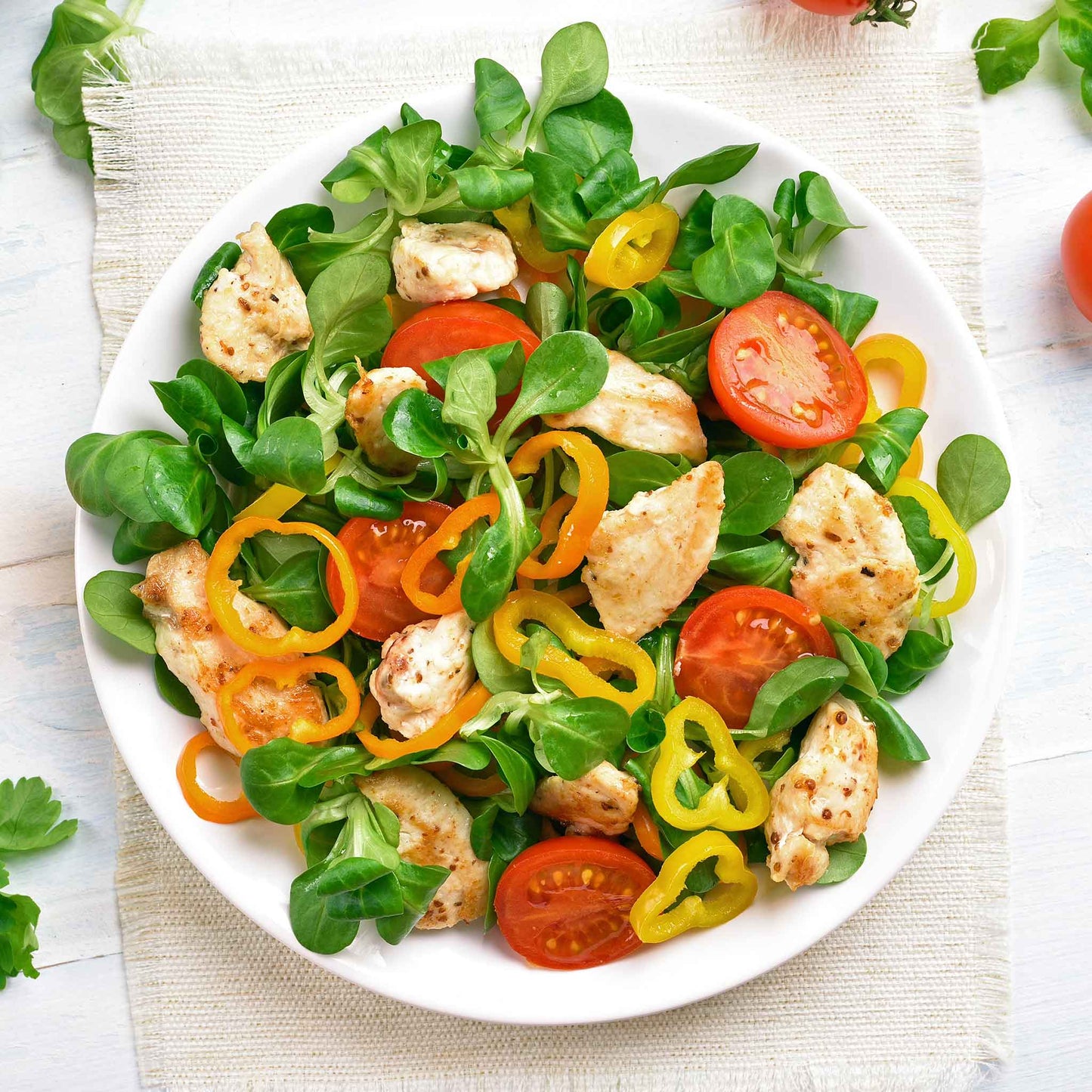 A salad made using Mache Corn Salad lettuce with pepper and tomatoes.