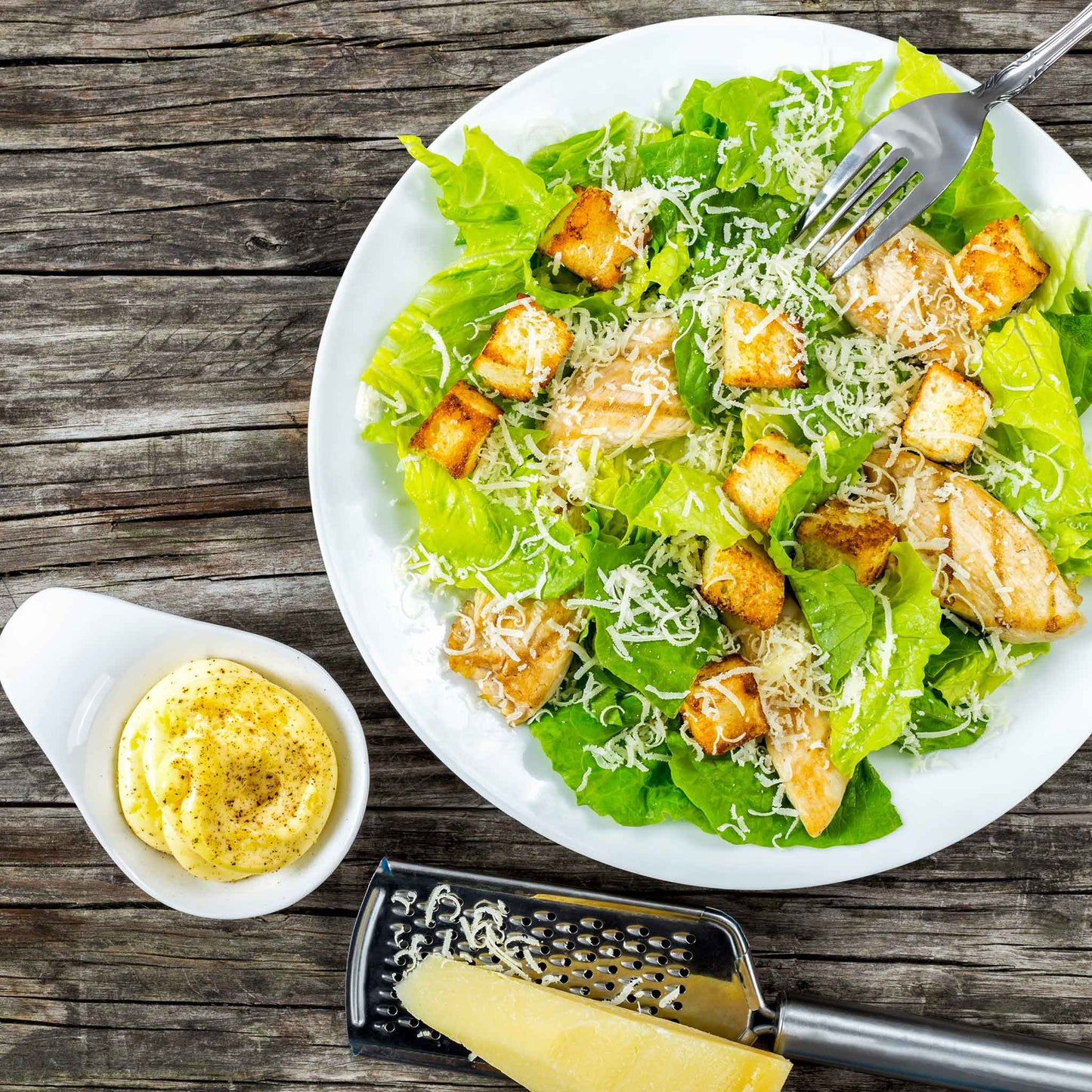 A salad made with Paris White Cos lettuce on a wooden surface.
