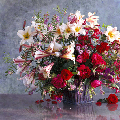 White lily regale trumpet-shaped blooms with yellow throats in a colorful bouquet setting.