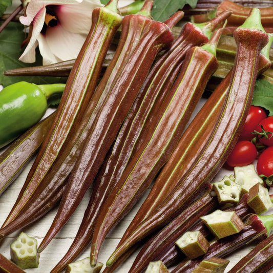 Several elongated Red Burgundy okra showing its deep red skin and green stems.