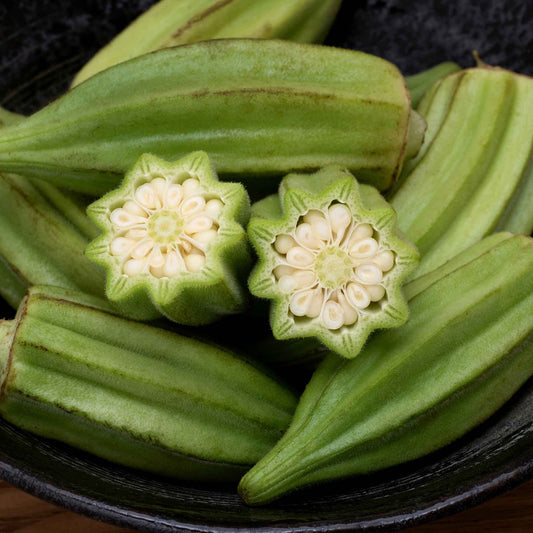A close-up shot of several Star of David okra pods showing the short bodies and distince star cross section.