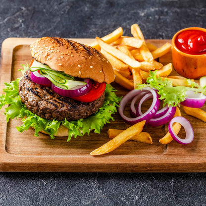 A platter of burger and fries showing sliced Red Burgundy onions on and off the burger.