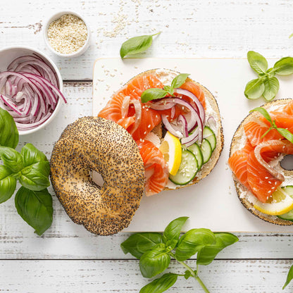 A bagel using sliced Red Grano onions as one of the toppings.