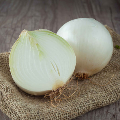 A sliced White Sweet Spanish onion showing the white skin and interior.
