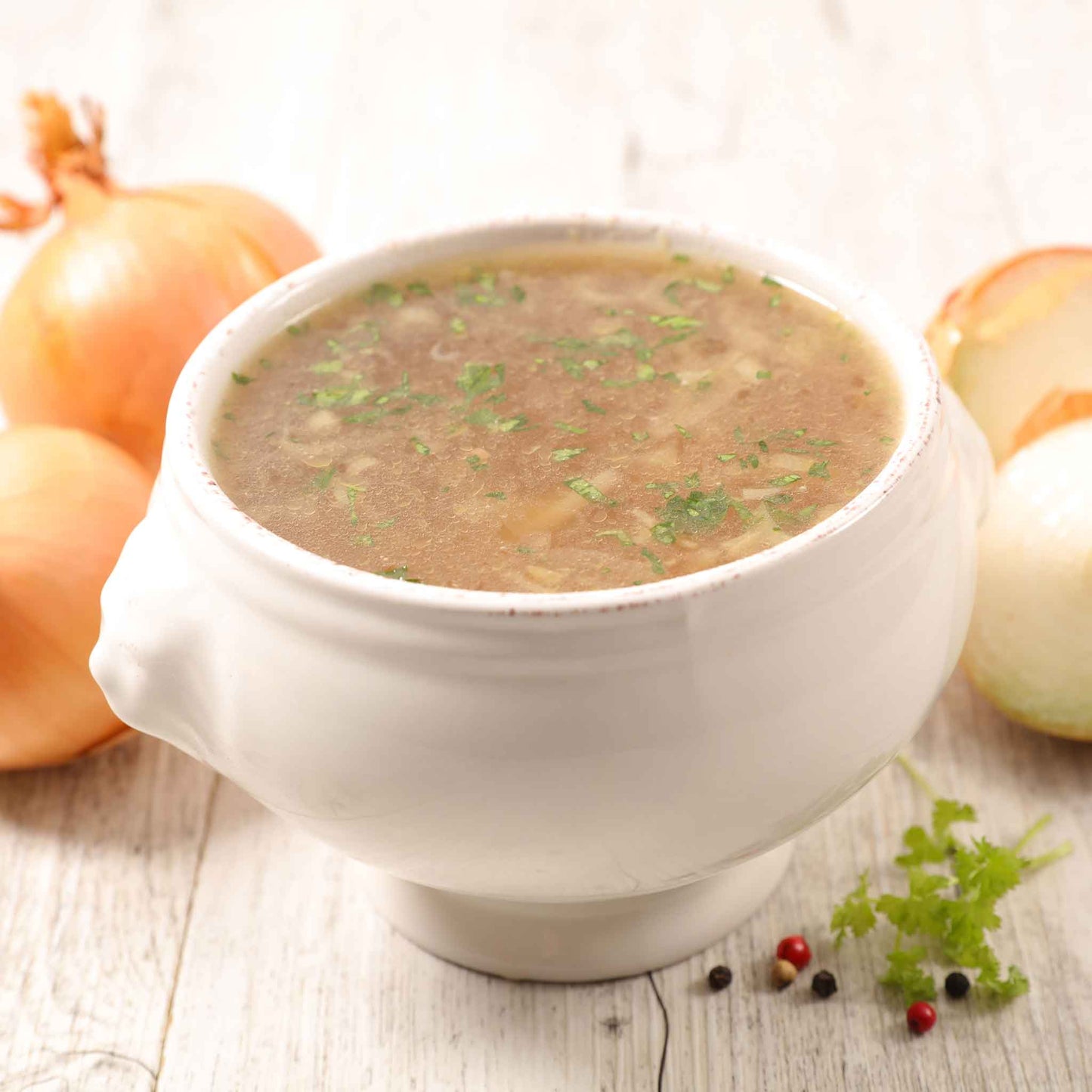 A bowl of soup using Yellow Sweet Spanish onions with other onions in the background.