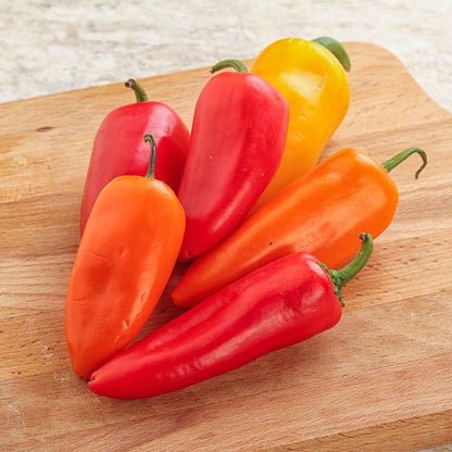 Bright orange and red Santa Fe Grande peppers, showcasing their smooth skin and vibrant color.