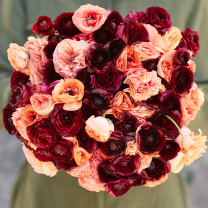 Red and pink ranunculus princess bride mix blooms on a natural backdrop