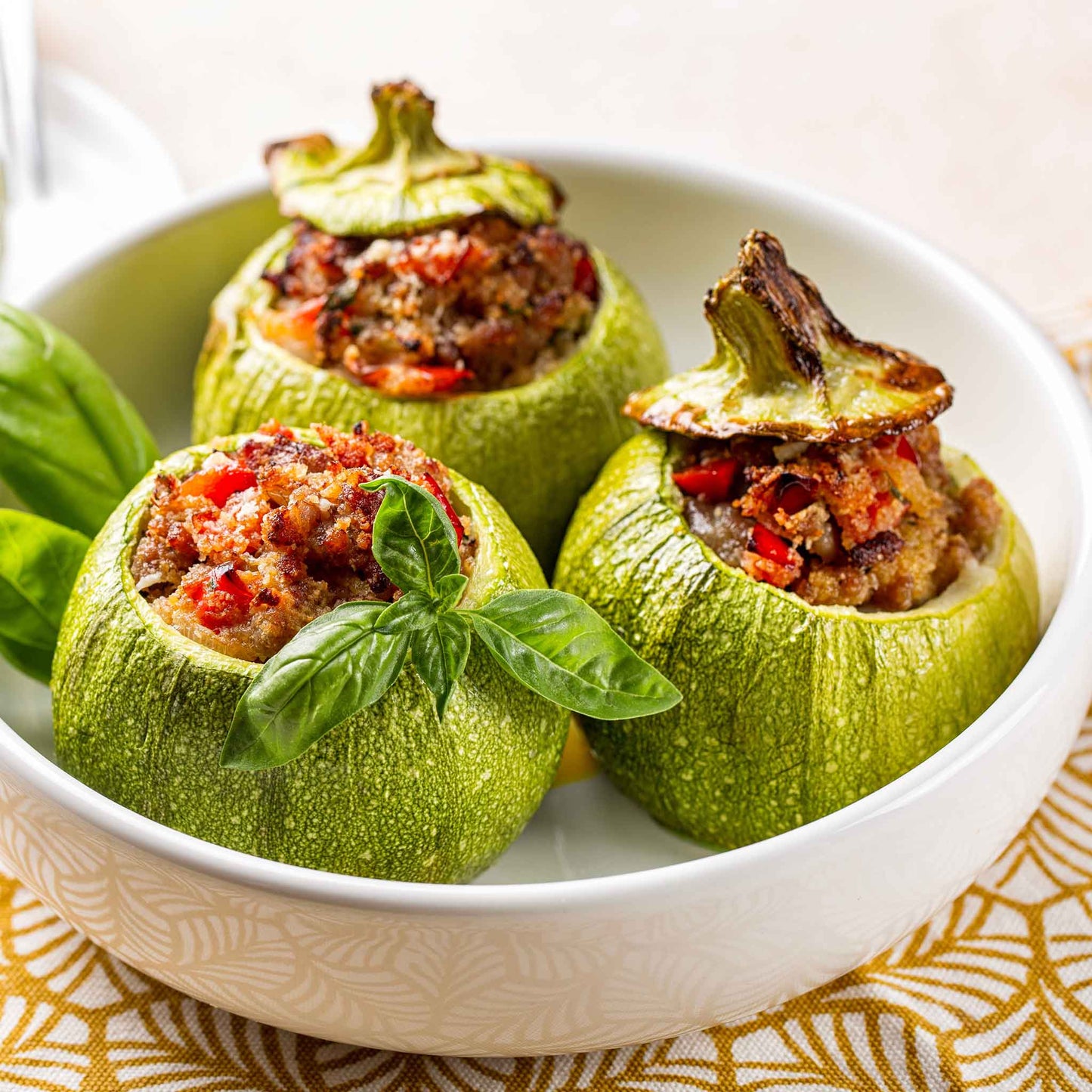 Stuffed Round Zucchini squash on a deep white plate.