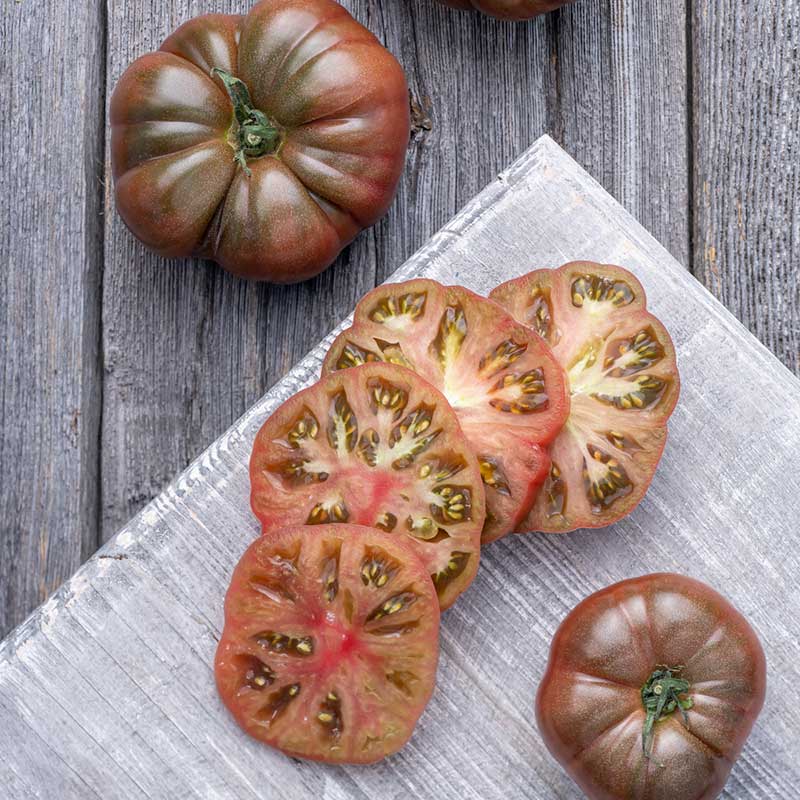 A Black Krim tomato sliced and whole. | copyright: Floramedia UK Ltd