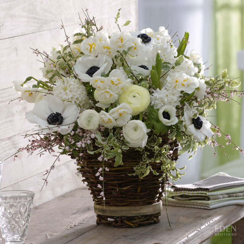 A vase with vibrant white garden collection flowers.